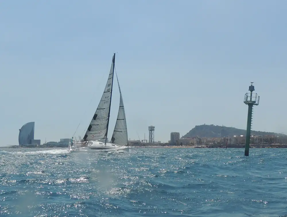 El ganador de la categoría Tripulación Completa, Seven Too, cruzando la línea de llegada en el Port Olímpic.
